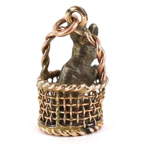 3171 - A 9ct gold charm in the form of a basket with a silver rabbit, 1.7cm high, 4.0g.