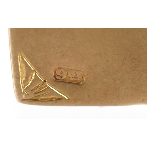 3118 - A 9ct gold charm in the form of a book inscribed 'Love Story', 1.3cm high, 1.4g.