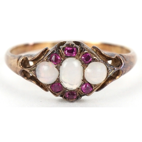 3165 - An antique unmarked gold graduated opal and ruby cluster ring with pierced shoulders, size N, 2.1g.