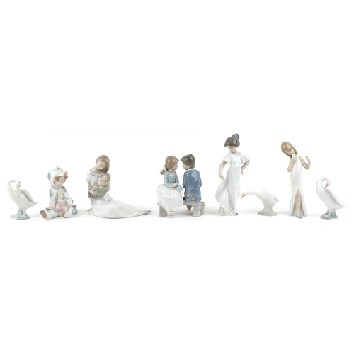 628 - Eight Lladro and Nao porcelain figures and animals including a child in a cow costume, a young boy a... 