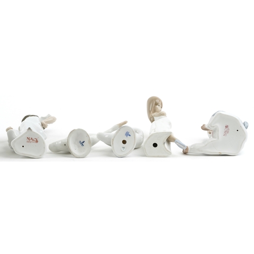 628 - Eight Lladro and Nao porcelain figures and animals including a child in a cow costume, a young boy a... 