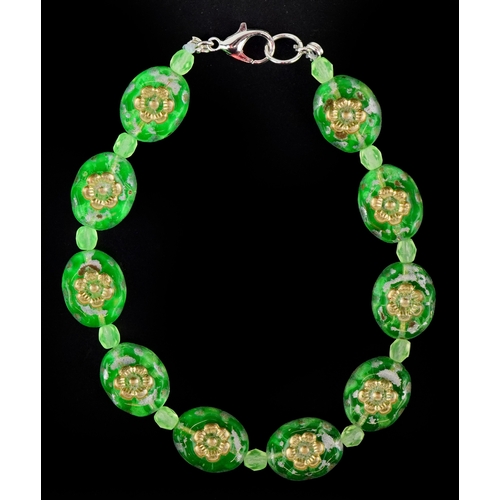 3387 - A uranium glass bead bracelet with floral design, 19cm in length, 14.1g.