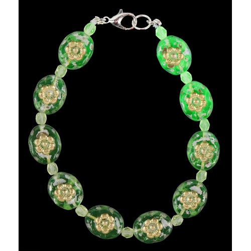3387 - A uranium glass bead bracelet with floral design, 19cm in length, 14.1g.
