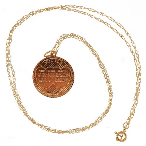 3144 - A 9ct gold Mizpah pendant on a 9K gold necklace, 1.6cm in diameter and 50cm in length, total 2.1g.