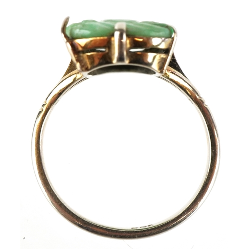A Chinese 9ct gold and green stone ring carved with Buddha, tests as ...