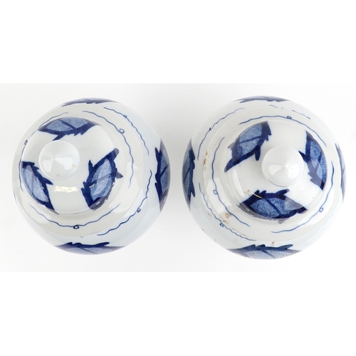 465 - A matched pair of Chinese blue and white porcelain vases and covers hand painted with fish, the larg... 