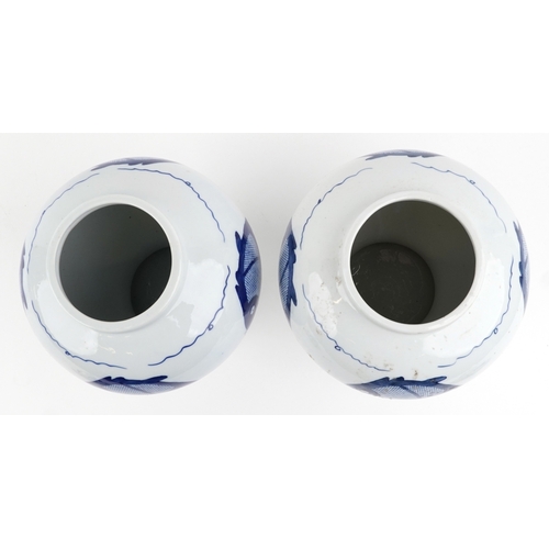 465 - A matched pair of Chinese blue and white porcelain vases and covers hand painted with fish, the larg... 