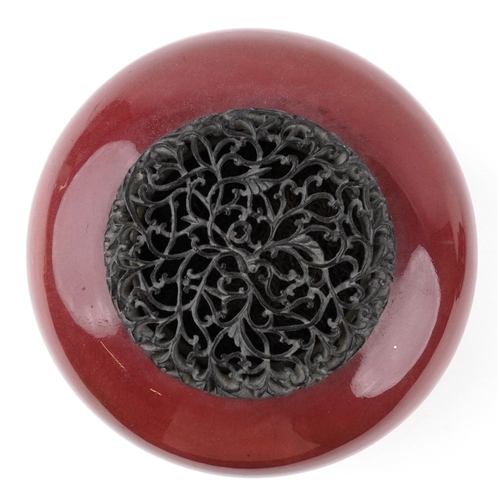 86 - A large Chinese porcelain vase and cover with sang de boeuf glaze, raised on an ebonised carved wood... 