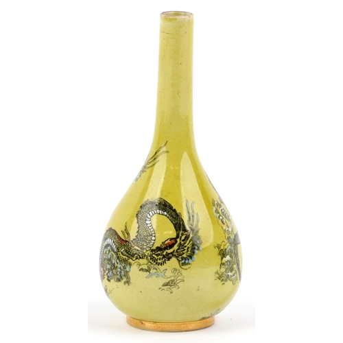 323 - A Doulton Lambeth Aesthetic movement bottleneck vase decorated with dragons amongst enamelled waves ... 