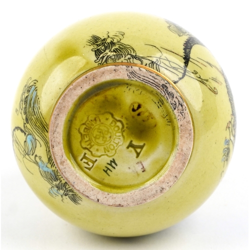 323 - A Doulton Lambeth Aesthetic movement bottleneck vase decorated with dragons amongst enamelled waves ... 