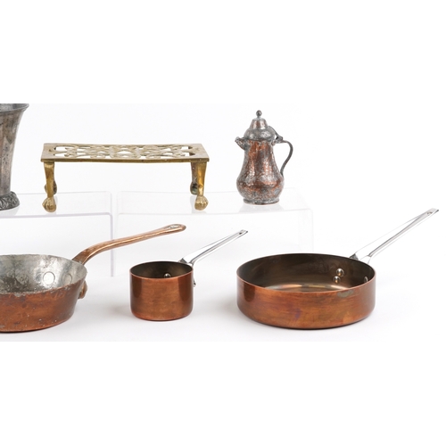 1786 - Antique metalware including a brass trivet, copper warming pans and jelly moulds, the largest 40cm i... 