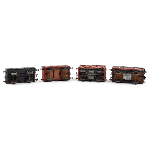 733 - Four vintage scratch built O gauge model railway wagons, the largest 12cm in length.