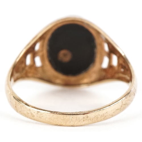 3034 - A 9ct gold onyx Playboy Bunny signet ring, size R/S, 3.2g.