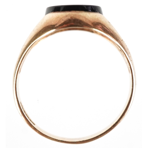 3034 - A 9ct gold onyx Playboy Bunny signet ring, size R/S, 3.2g.