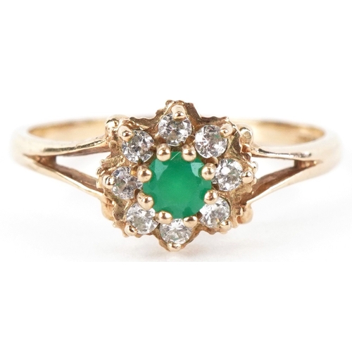 3170 - A 9ct gold green stone and clear stone flower head ring with split shoulders, size M, 1.6g.