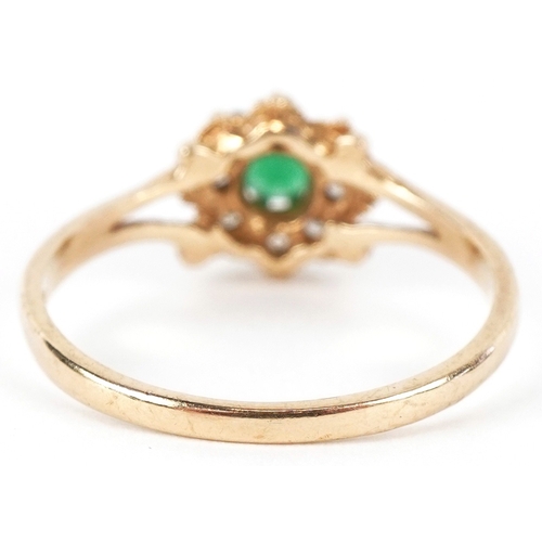3170 - A 9ct gold green stone and clear stone flower head ring with split shoulders, size M, 1.6g.