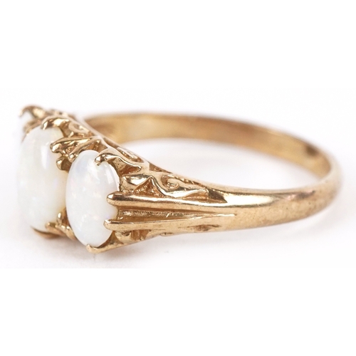 3120 - A 9ct gold graduated opal trilogy ring, size L/M, 2.4g.
