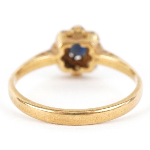 3097 - An 18ct gold diamond and blue spinel flower head ring, size L, 2.3g.
