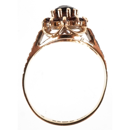 3189 - A 9ct gold two tier garnet cluster ring with engraved shoulders, size M, 2.7g.