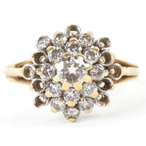 3198 - An 18ct gold diamond four tier cluster ring, the central diamond approximately 3.80mm in diameter, s... 