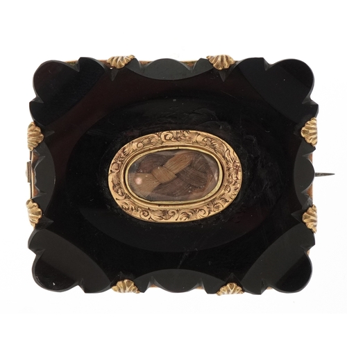 An antique gilt metal onyx mourning brooch with hairwork panel, 5cm wide, 18.2g.