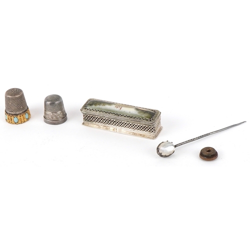 1468 - A small group of objects of Vertu including a moonstone mounted hatpin, two thimbles and a needle ca... 