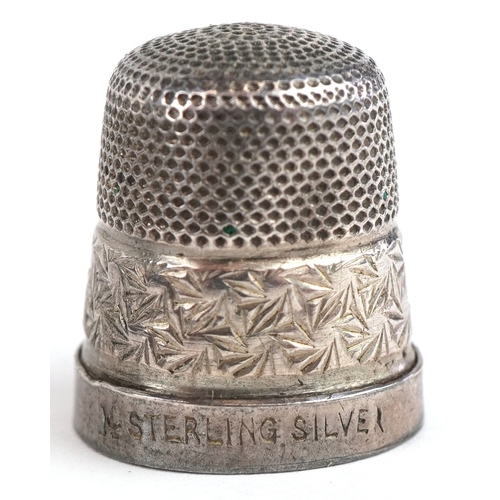 1468 - A small group of objects of Vertu including a moonstone mounted hatpin, two thimbles and a needle ca... 