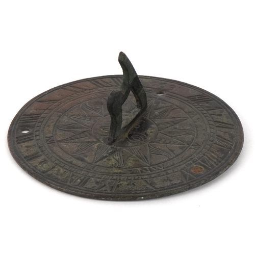 1798 - A bronze sundial with engraved decoration, dated 1692 , 13cm in diameter.