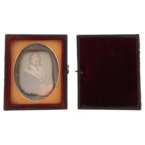 309 - A 19th century daguerreotype of a young female, housed in a velvet lined case, 7cm x 6cm.