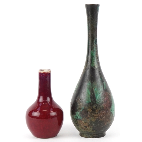 452 - A Chinese patinated bronze bottleneck vase together with a diminutive porcelain vase having a sang d... 