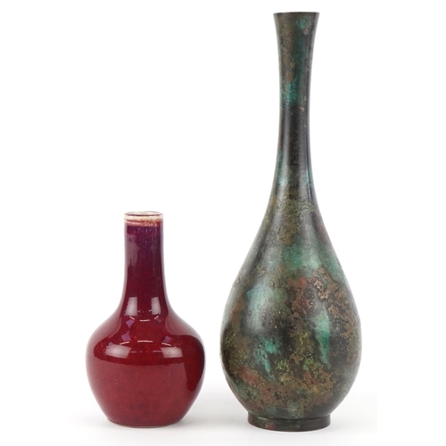 452 - A Chinese patinated bronze bottleneck vase together with a diminutive porcelain vase having a sang d... 