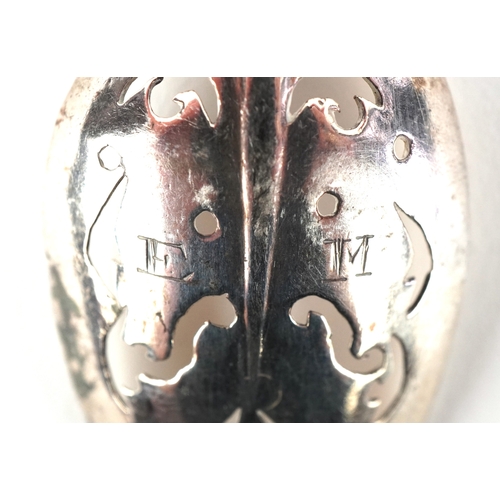 3667 - An 18th century silver mote spoon, the bowl pierced with scroll decoration, 15cm in length, 9.2g.