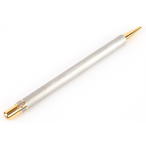 54 - Cartier, a stainless steel and gold plated Must de Cartier ballpoint pen numbered B95471, with box a... 