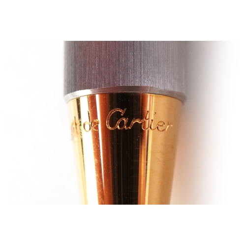 54 - Cartier, a stainless steel and gold plated Must de Cartier ballpoint pen numbered B95471, with box a... 