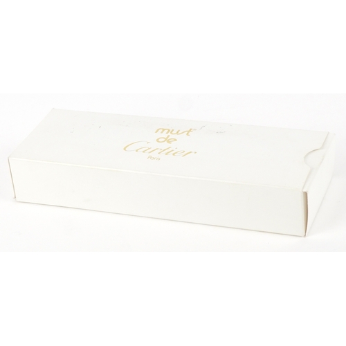 54 - Cartier, a stainless steel and gold plated Must de Cartier ballpoint pen numbered B95471, with box a... 