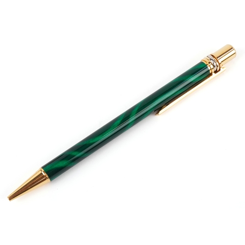 55 - Cartier, a malachite design and gold plated ballpoint pen numbered B85336, with box and paperwork.