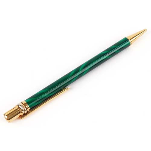 55 - Cartier, a malachite design and gold plated ballpoint pen numbered B85336, with box and paperwork.