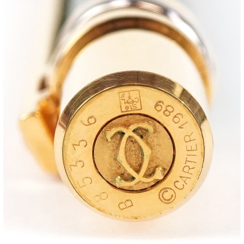 55 - Cartier, a malachite design and gold plated ballpoint pen numbered B85336, with box and paperwork.
