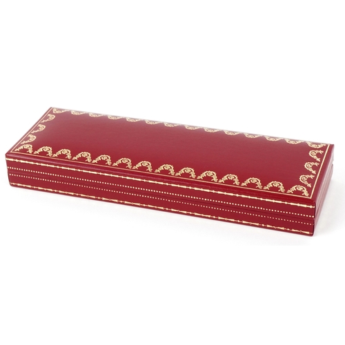 55 - Cartier, a malachite design and gold plated ballpoint pen numbered B85336, with box and paperwork.