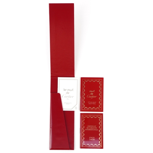 55 - Cartier, a malachite design and gold plated ballpoint pen numbered B85336, with box and paperwork.