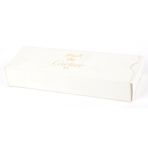 55 - Cartier, a malachite design and gold plated ballpoint pen numbered B85336, with box and paperwork.