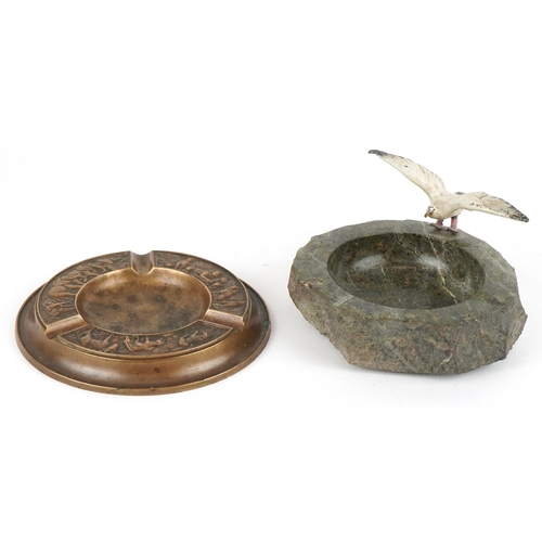 499 - Two ashtrays comprising a London Bronze ashtray embossed with animals and a Cornish serpentine ashtr... 