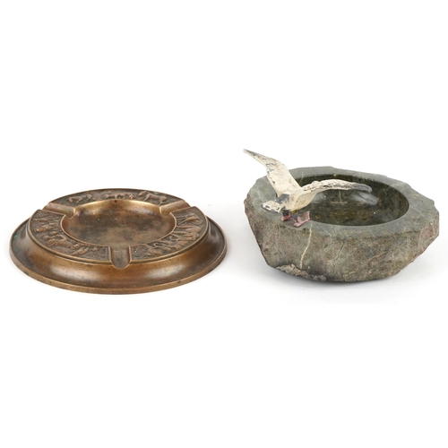 499 - Two ashtrays comprising a London Bronze ashtray embossed with animals and a Cornish serpentine ashtr... 
