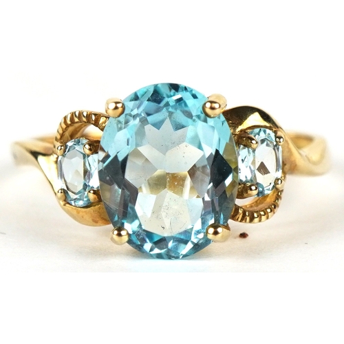 3149 - A 9ct gold topaz trilogy ring, size P, 2.6g.
