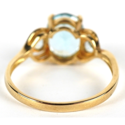 3149 - A 9ct gold topaz trilogy ring, size P, 2.6g.