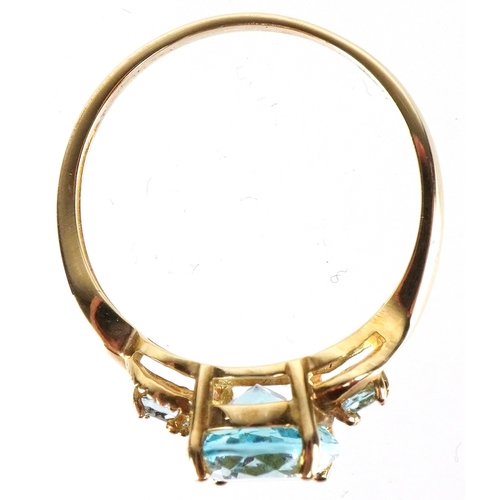 3149 - A 9ct gold topaz trilogy ring, size P, 2.6g.