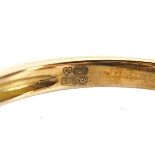 3149 - A 9ct gold topaz trilogy ring, size P, 2.6g.