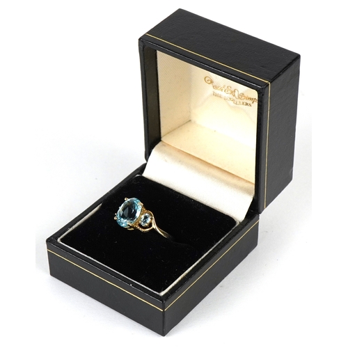 3149 - A 9ct gold topaz trilogy ring, size P, 2.6g.