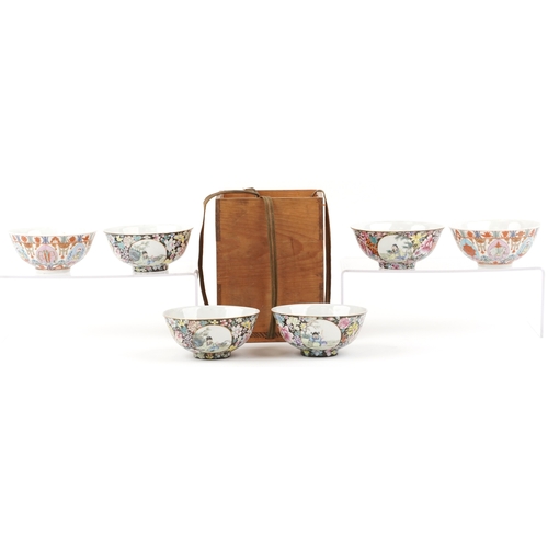 1765 - A set of four Chinese porcelain footed bowls hand painted in the famille noire palette with panels o... 