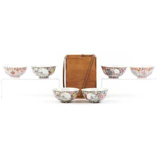 1765 - A set of four Chinese porcelain footed bowls hand painted in the famille noire palette with panels o... 